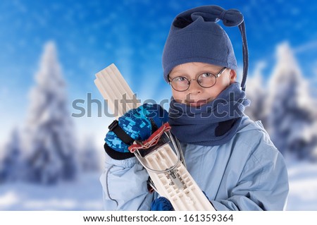Young Boy with skiing Equipment on winter landscape, little boy is focused on preparing for skiing