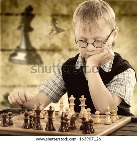 little boy plays chess, rustic chess background