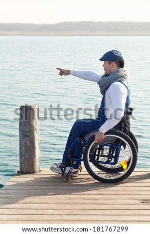 spring vacation: man in wheelchair enjoying outdoors beach