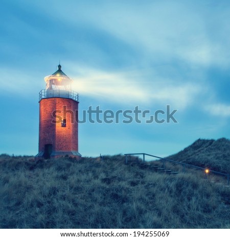 landscape at the North sea with a lightning lighthouse