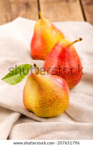 Fresh juicy pears on wooden table on rustic background