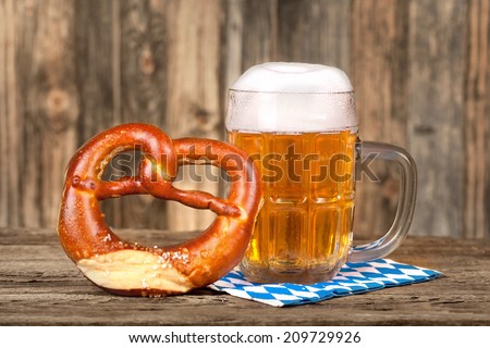 German Food: Pretzel and beer on bavarian napkin; selective focus