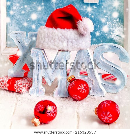 christmas decoration with red christmas balls and letters of wood \