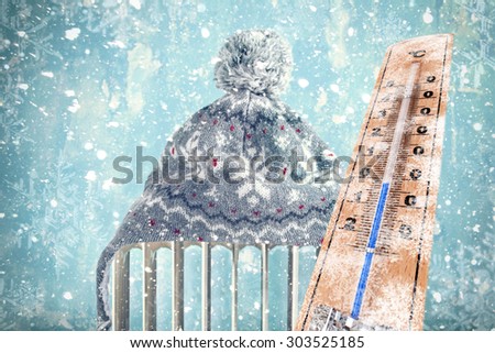 frozen Thermometer, hat on a heater, it`s winter