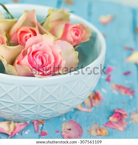 weathered wood with bowl of water and flowers