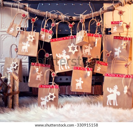 paper bags as part of an Advent calendar hanging from a mantel or fireplace, decorated for Christmas