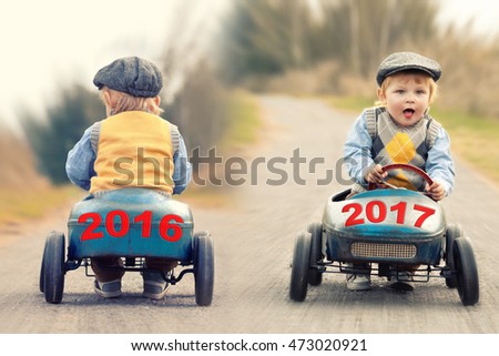 old year 2016 on a vintage old toy car leaving, new year 2017 on a vintage old toy car is coming
