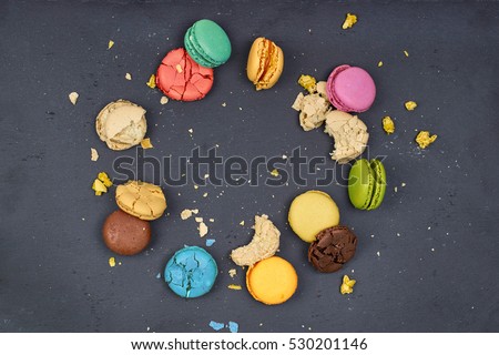 some appetizing macaroons of different flavors on a slate surface