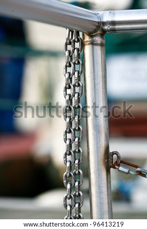 silver metal chains hanging from silver metal railings
