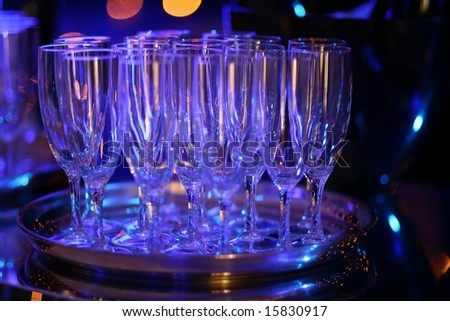 wine glasses on tray on night club bar