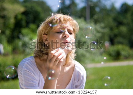 The young women makes soap bubbles
