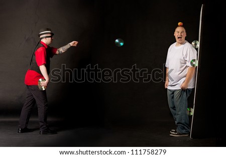 man throwing cds towards a victim