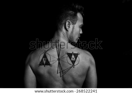 Man back with tattoo in black and white