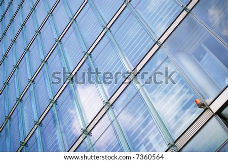 security light at a glassed business building with reflecting sky