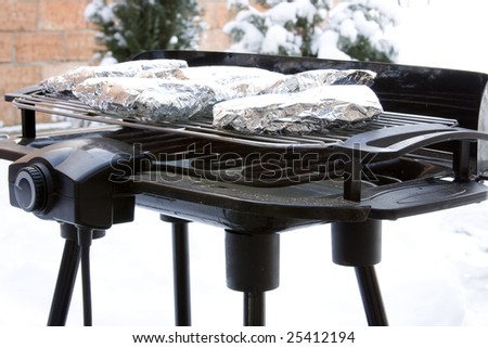 Barbecue grill covered in Snow