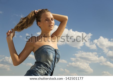 beautiful girl draw back a hair into ponytail