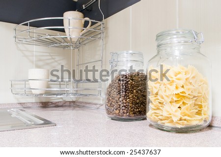Pasta and coffee beans in glass jars in kitchen interior