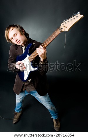 Young man playing electro guitar, high angle view