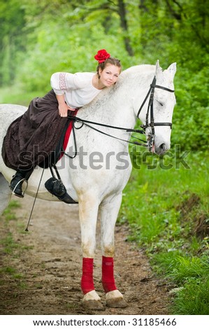 Beautiful girl with horse in the forest