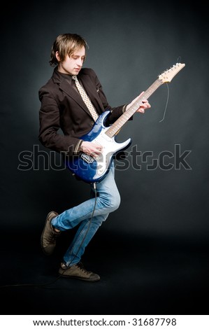 Man with electro guitar, studio shot