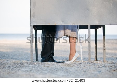 Bride and groom in dressing cabin on the beach