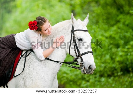 Beautiful girl riding horse in the forest