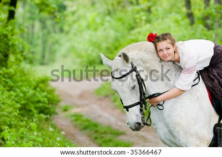 Cute girl riding horse in the forest