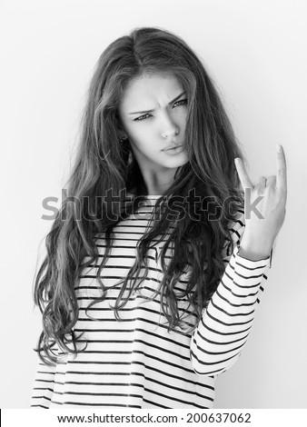 Beautiful model showing Rock and Roll sign Fresh clean skin and nude makeup Beautiful model showing Rock and Roll sign Fresh clean skin and nude makeup