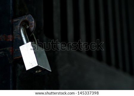 A silver metal lock on black door