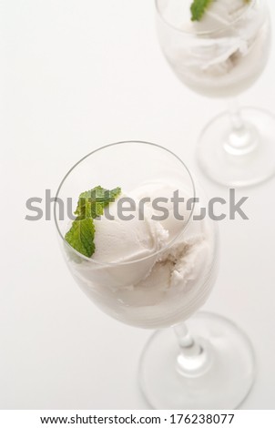 Coconut milk ice cream in glasses on white background