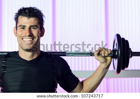 Happy fitness man training in gym Copy space.