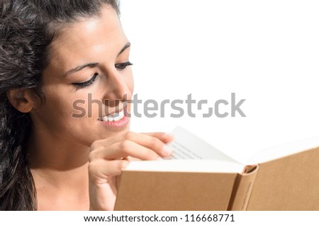 Cheerful woman reading a book and turning page on isolated white background.