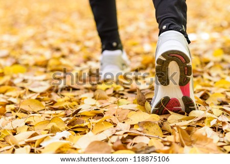 Running sport concept .Closeup of woman barefoot runner shoes. Female jogging on autumn. Copyspace.