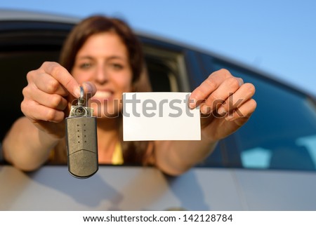 Happy teen girl showing new car keys and driving license.