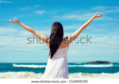 Summer Freedom On The Beach. Joyful Woman Raising Arms To The Sky, Enjoying Travel And Vacation On Coast. Playa De Verdicio, Asturias, Spain.