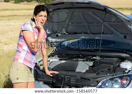 Upset woman after car accident or broken down engine waiting for insurance road assistance service help.