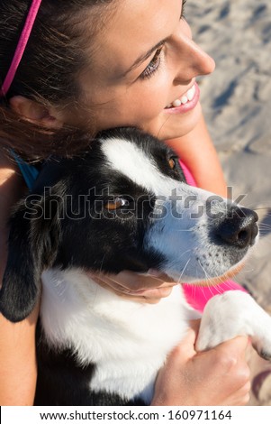 Happy woman embracing her loving and cute dog. Pet and human friendship.