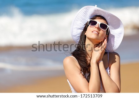 Relaxed woman on beach summer vacation. Girl enjoying freedom, leisure and relax listening the sea waves.