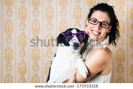 Funny woman and cute dog wearing glasses. Portrait of happy girl with her pet with eyewear.