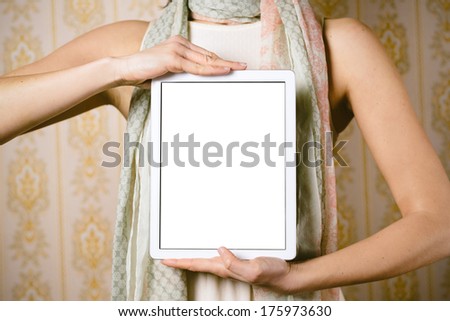 Fashion woman holding digital tablet with blank screen for copy space ad or message. Female showing touch pad display.