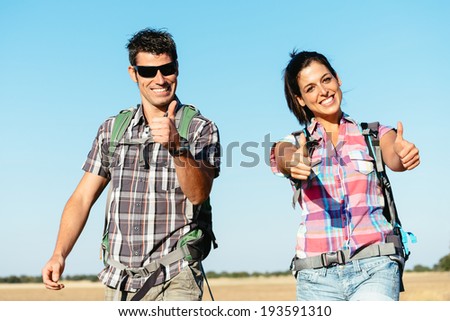 Young successful couple on summer hiking vacation in Castilla y Leon countryside, Spain. Positive man and woman on adventure backpacking travel.