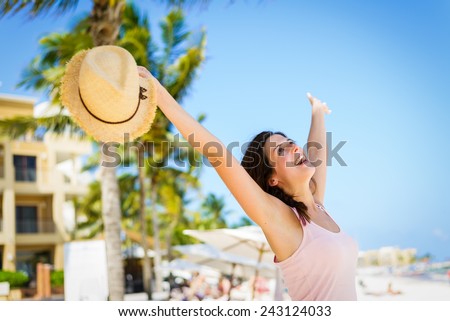 Relaxed cheerful woman enjoying tropical caribbean vacation at the beach in Playa del Carmen, Riviera Maya, Mexico.