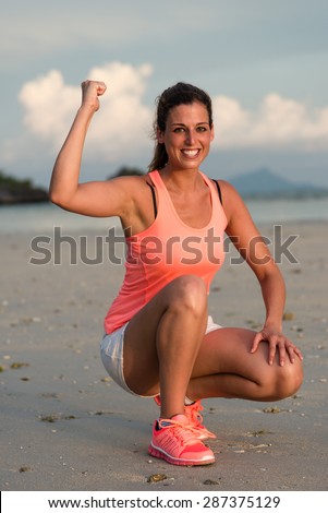Motivated woman ready for running and fitness exercising at beach on summer, Krabi, Thailand. Female athlete training outdoor.