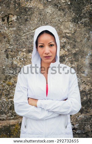 Motivated female athlete portrait. Sporty woman with arms crossed. Motivation and fitness lifestyle.