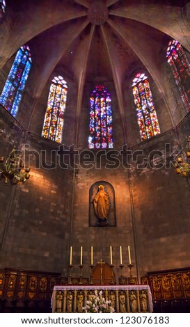 BARCELONA, SPAIN--OCTOBER 19:Stained glass, Mary statue with altar in St Maria del Pi, Saint Mary of Pine Tree, in Barcelona, Spain on October 19, 2012. One of the oldest churches in Barcelona.