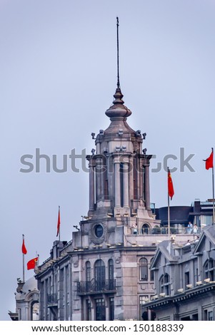 Old Bank Building, now used by a Chinese Bank, The Bund, Old Part, Shanghai, China with Flags. Old and Modern Buildings,