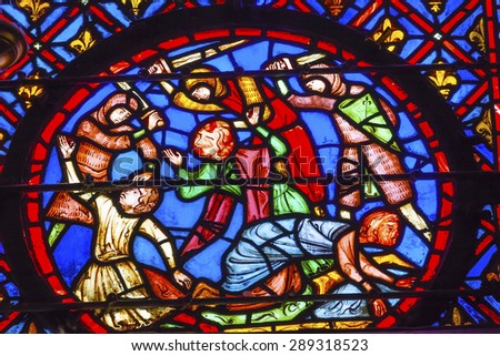 PARIS, FRANCE - JUNE 1, 2015 Knights Beheading Medieval Life Stained Glass Saint Chapelle Paris France.  Saint King Louis 9th created Sainte Chappel and stained glass in 1248.