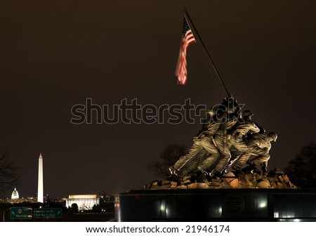 Marine Corps War Memorial Shows the Raising of the Flag at Iwo Jima Washington DC  Statue finished in 1954.  Lincoln Memorial, Washington Monument and Capital in the background.