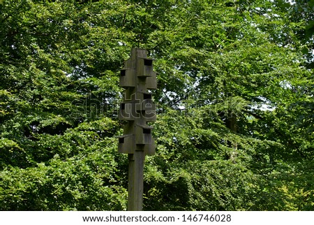Wooden bird house on a tree in a forest park