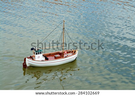 Sailing remote control model scale sail boat in a small lake